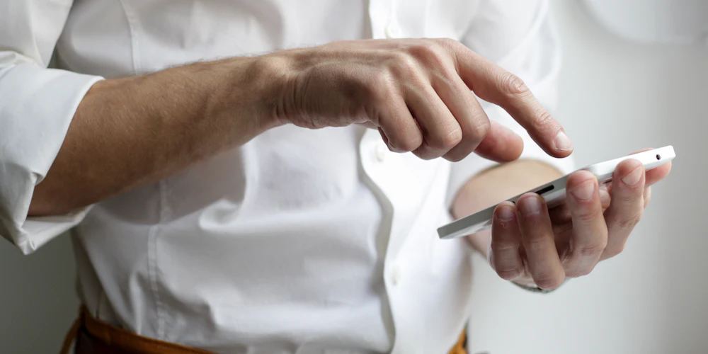Hand holding a smartphone using a mobile app