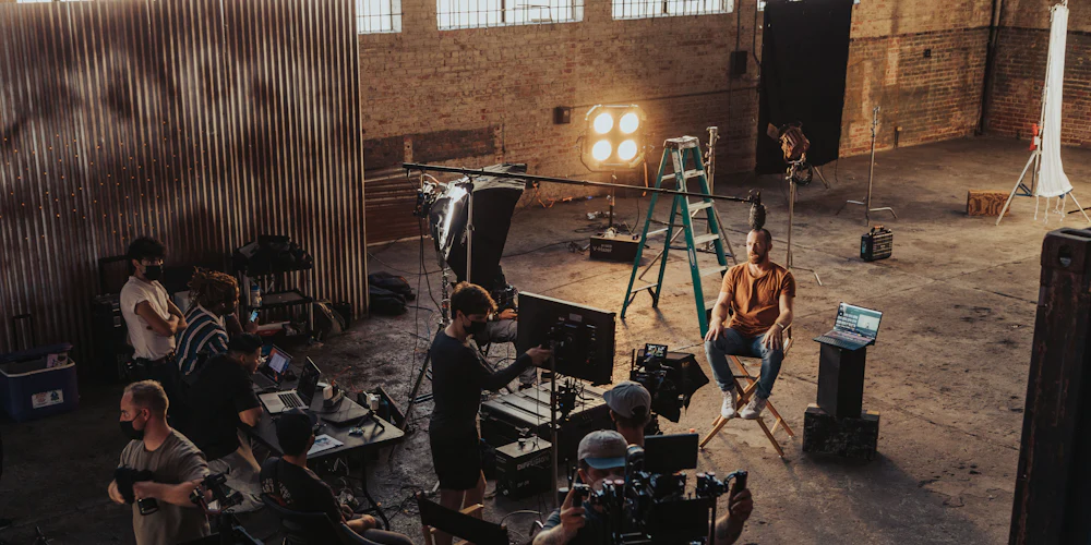 Film crew setting up cameras and lights for a video shoot